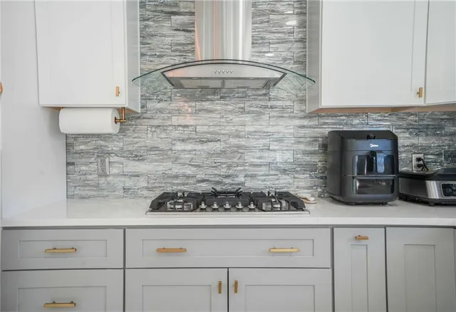 a kitchen with a stove and cabinets