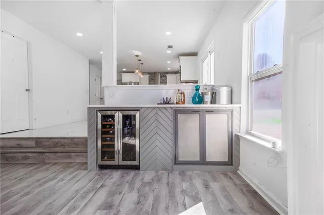 a view of a kitchen with furniture and wooden floor