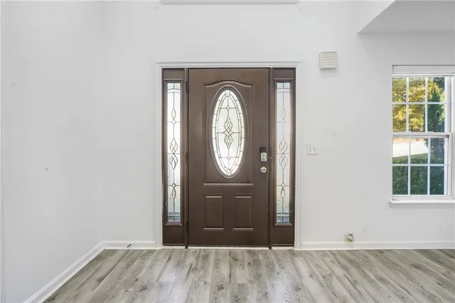 an empty room with mirror and windows