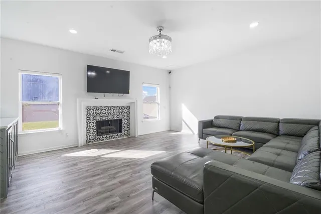 a living room with furniture a flat screen tv and a fireplace