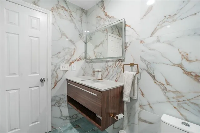 a bathroom with a sink a vanity and a shower
