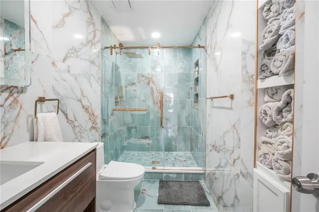 a bathroom with a sink toilet and shower