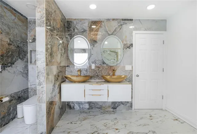 a bathroom with a sink mirror and vanity