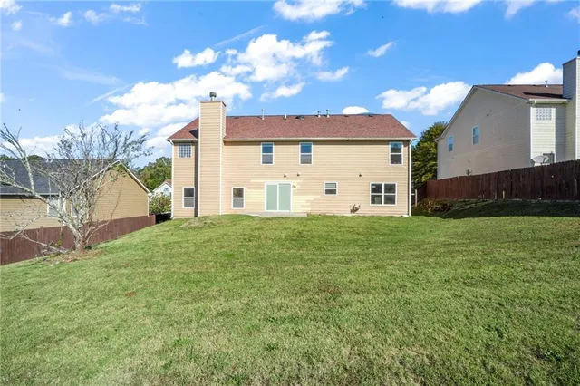 a view of a house with a back yard
