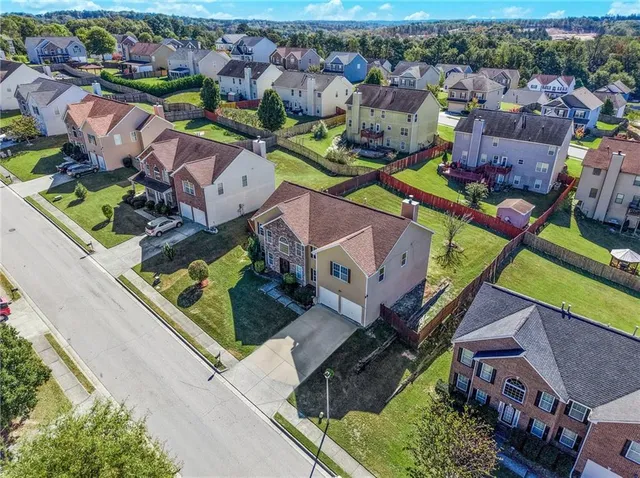 an aerial view of a house with a swimming pool yard and outdoor seating