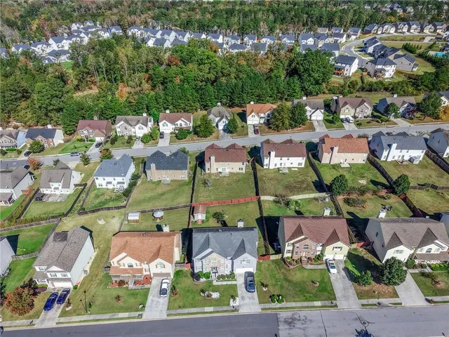 an aerial view of residential houses with outdoor space and street view