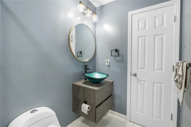 a bathroom with a toilet and a mirror