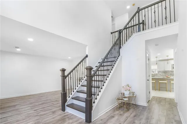 a view of entryway and hall with wooden floor
