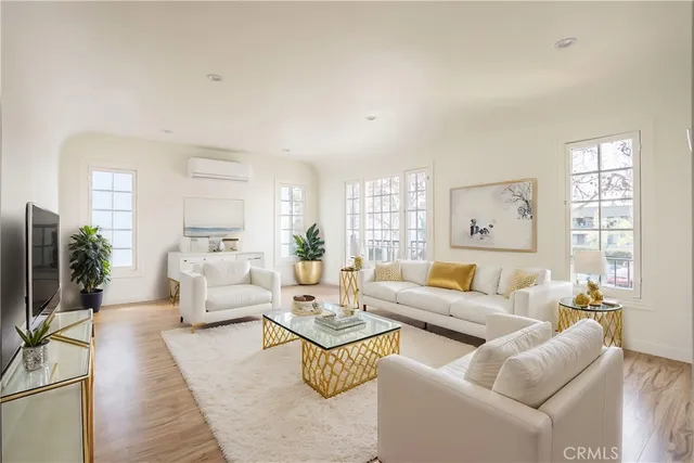 a living room with furniture wooden floor and a large window