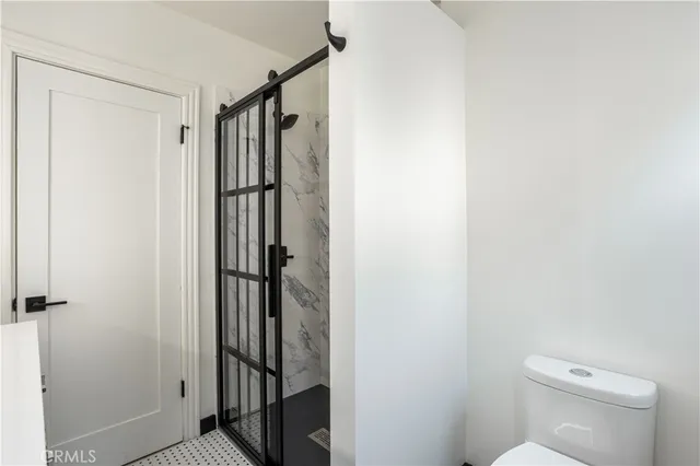 a bathroom with a shower toilet and sink