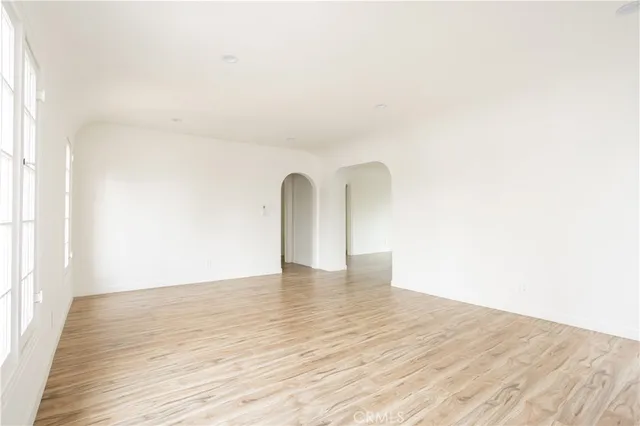 a view of a room with wooden floor and white wall