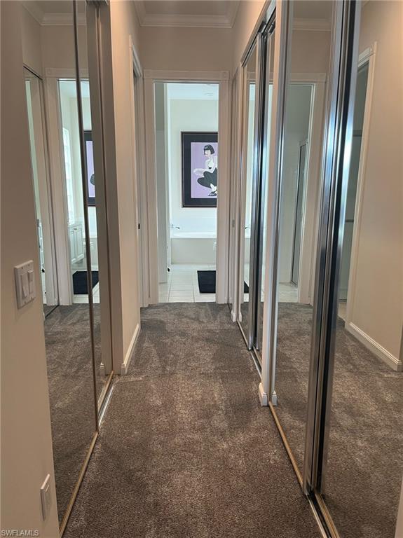 5477 Freeport Lane Naples, FL 34119 - Photo 14 of 36 a view of a hallway with wooden floor and stairs