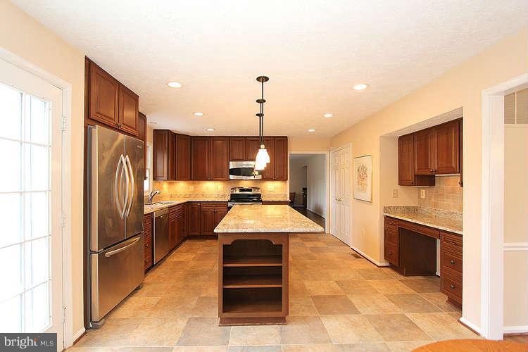 2213 Wakerobin Lane Reston, VA 20191 - Photo 14 of 28 a kitchen with refrigerator cabinets and counter top space