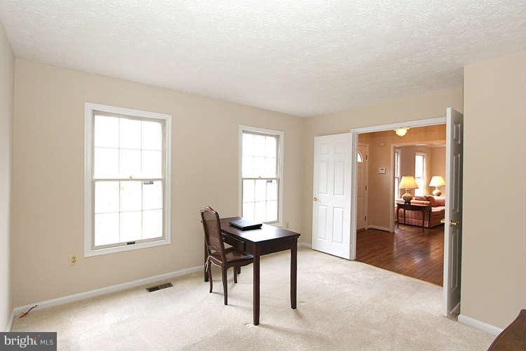 2213 Wakerobin Lane Reston, VA 20191 - Photo 3 of 28 a view of a livingroom with a chair and dining table with chandelier