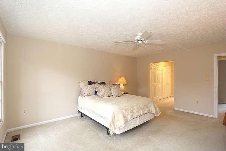 2213 Wakerobin Lane Reston, VA 20191 - Photo 22 of 28 a bedroom with a bed and a ceiling fan