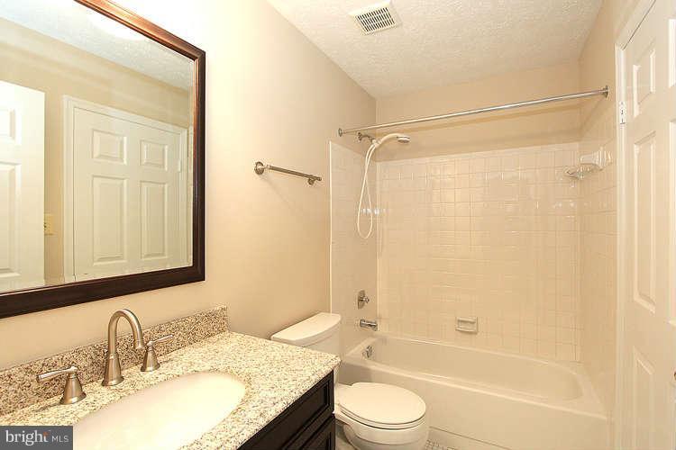 2213 Wakerobin Lane Reston, VA 20191 - Photo 4 of 28 a bathroom with a granite countertop sink toilet and shower