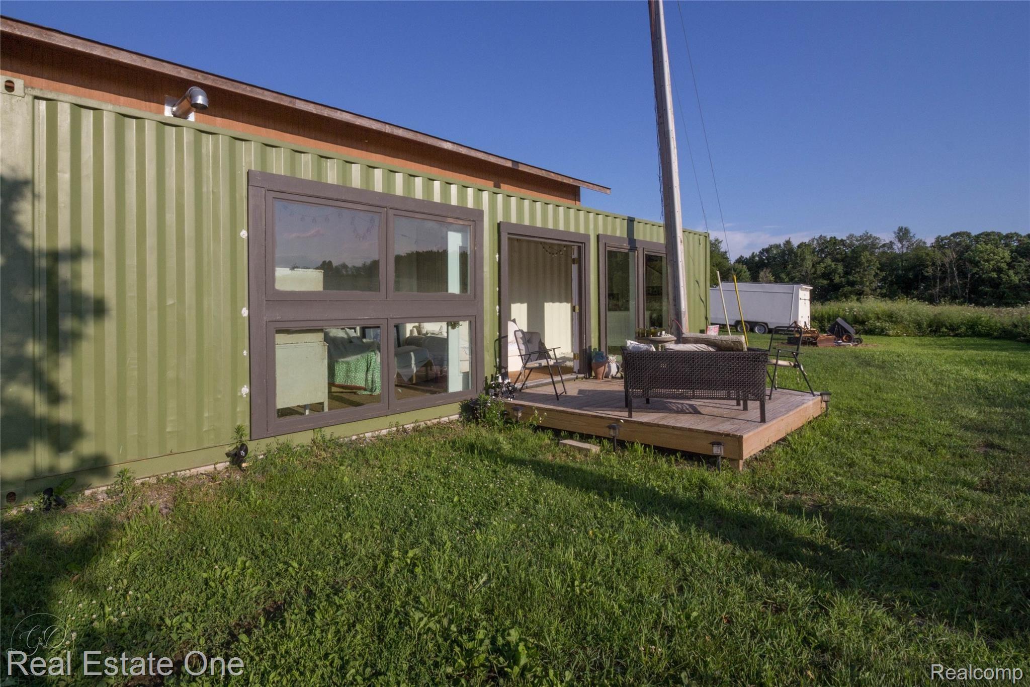1350 Bone Road Fenton, MI 48430 - Photo 52 of 67 9 1/2 foot tall 40 foot long shipping container converted to art studio/bar. facing 30 acres.