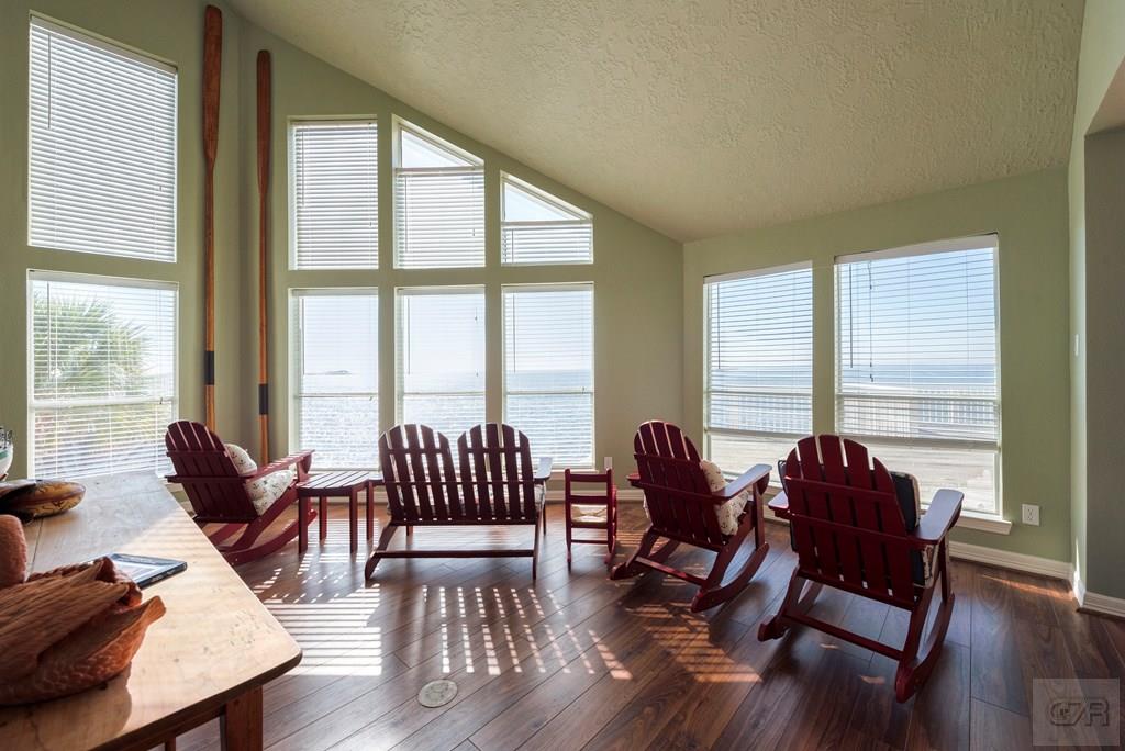 131 Isles End Road Tiki Island, TX 77554 - Photo 11 of 48 a living room with furniture and floor to ceiling windows