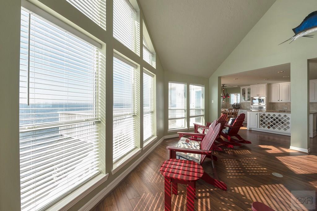 131 Isles End Road Tiki Island, TX 77554 - Photo 12 of 48 a living room with furniture and floor to ceiling windows