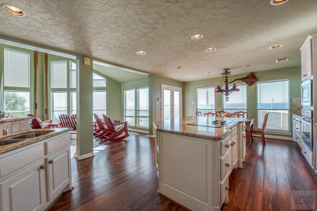 131 Isles End Road Tiki Island, TX 77554 - Photo 14 of 48 a view of a kitchen and dining room with furniture window wooden floor