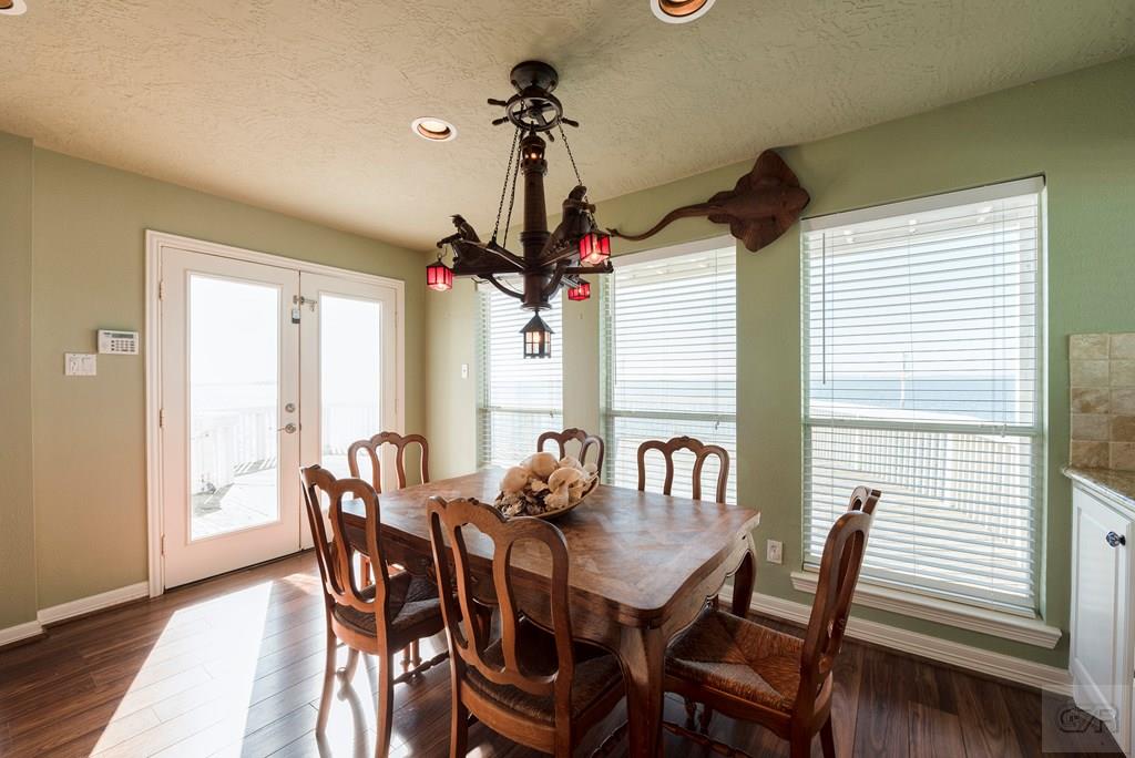 131 Isles End Road Tiki Island, TX 77554 - Photo 15 of 48 a view of a dining room with furniture window and wooden floor