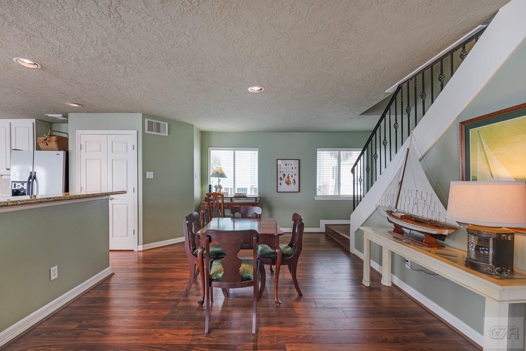 131 Isles End Road Tiki Island, TX 77554 - Photo 17 of 48 a view of a dining room with furniture window and wooden floor