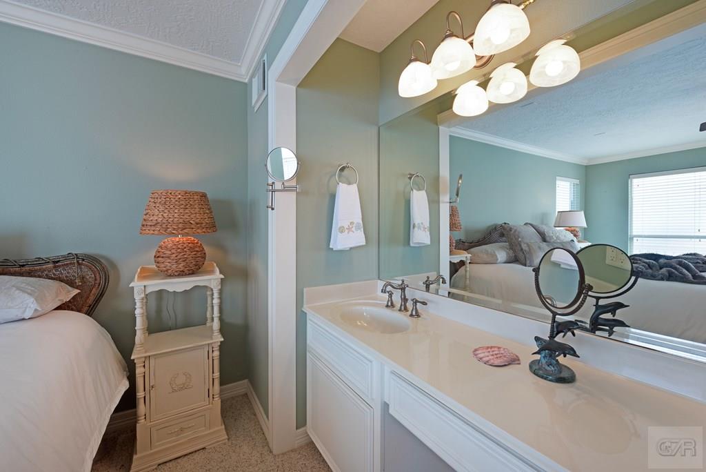 131 Isles End Road Tiki Island, TX 77554 - Photo 21 of 48 a bathroom with a sink and a mirror
