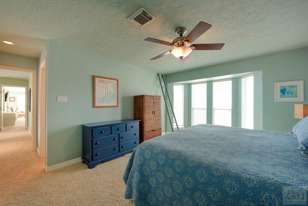 131 Isles End Road Tiki Island, TX 77554 - Photo 25 of 48 a spacious bedroom with a bed and a dresser