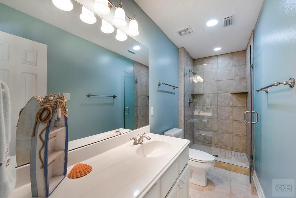 131 Isles End Road Tiki Island, TX 77554 - Photo 26 of 48 a bathroom with a sink a toilet and shower