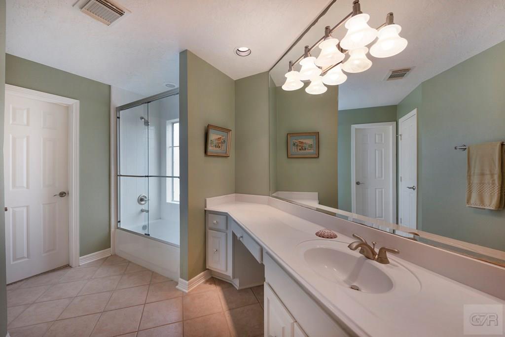 131 Isles End Road Tiki Island, TX 77554 - Photo 29 of 48 a bathroom with a sink vanity and a mirror