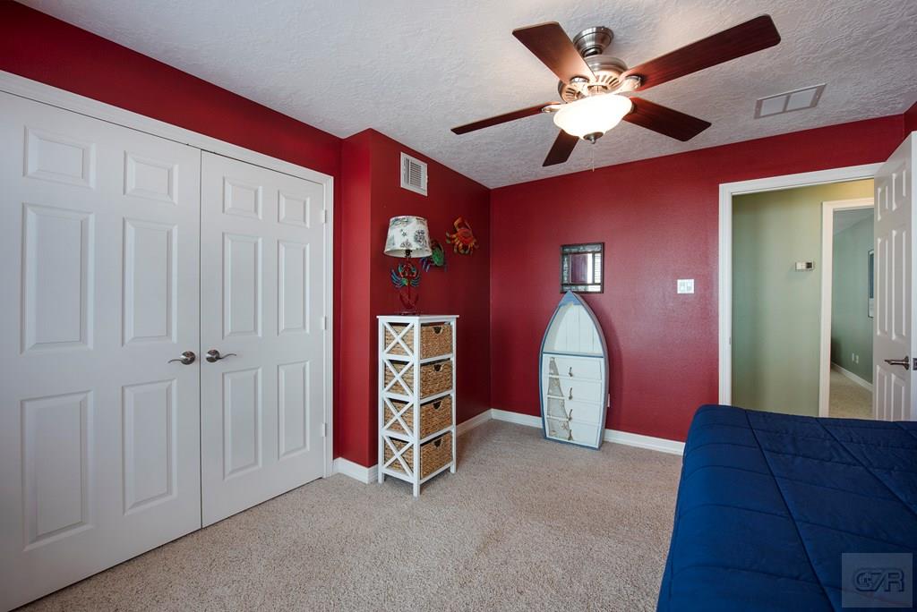 131 Isles End Road Tiki Island, TX 77554 - Photo 31 of 48 a view of a livingroom with a chandelier fan and a kitchen