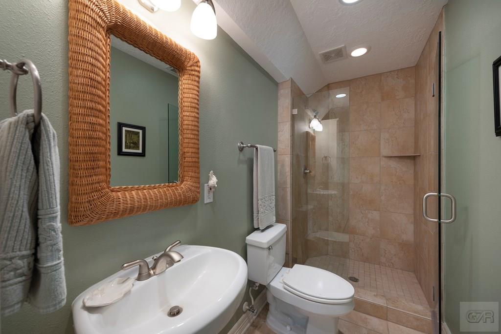 131 Isles End Road Tiki Island, TX 77554 - Photo 32 of 48 a bathroom with a sink toilet and shower