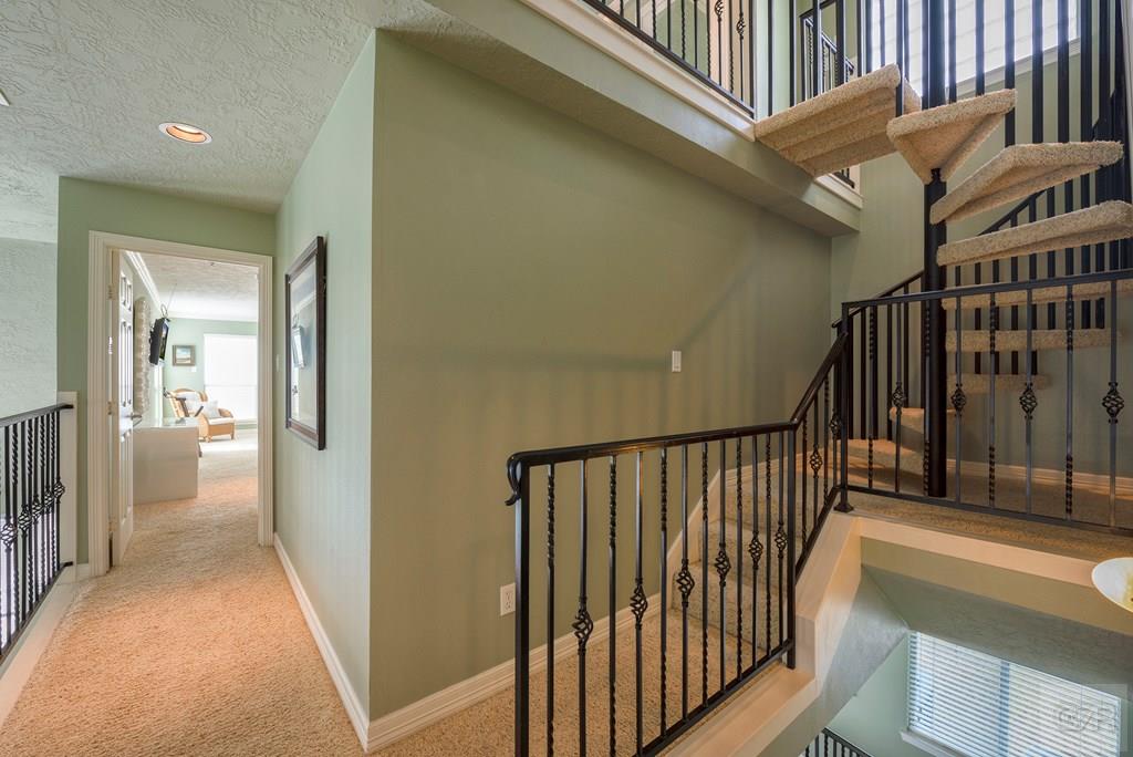 131 Isles End Road Tiki Island, TX 77554 - Photo 33 of 48 a view of a hallway with wooden floor and stairs