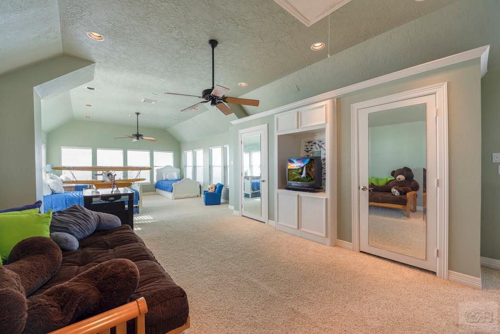 131 Isles End Road Tiki Island, TX 77554 - Photo 34 of 48 a living room with furniture a chandelier and a large window