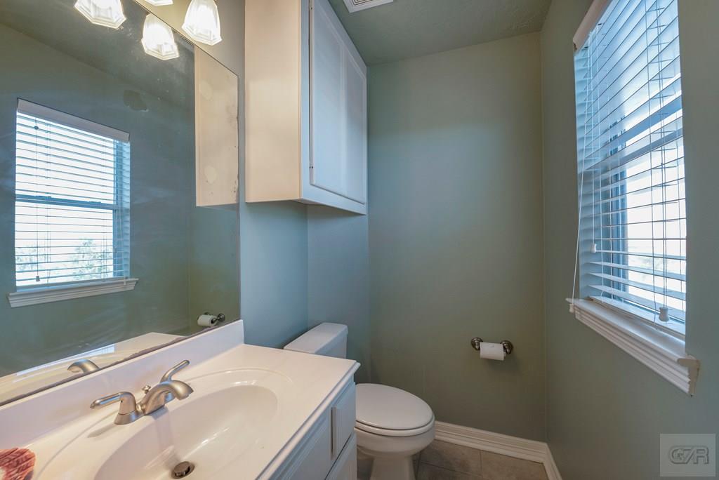 131 Isles End Road Tiki Island, TX 77554 - Photo 37 of 48 a bathroom with a sink a toilet and window