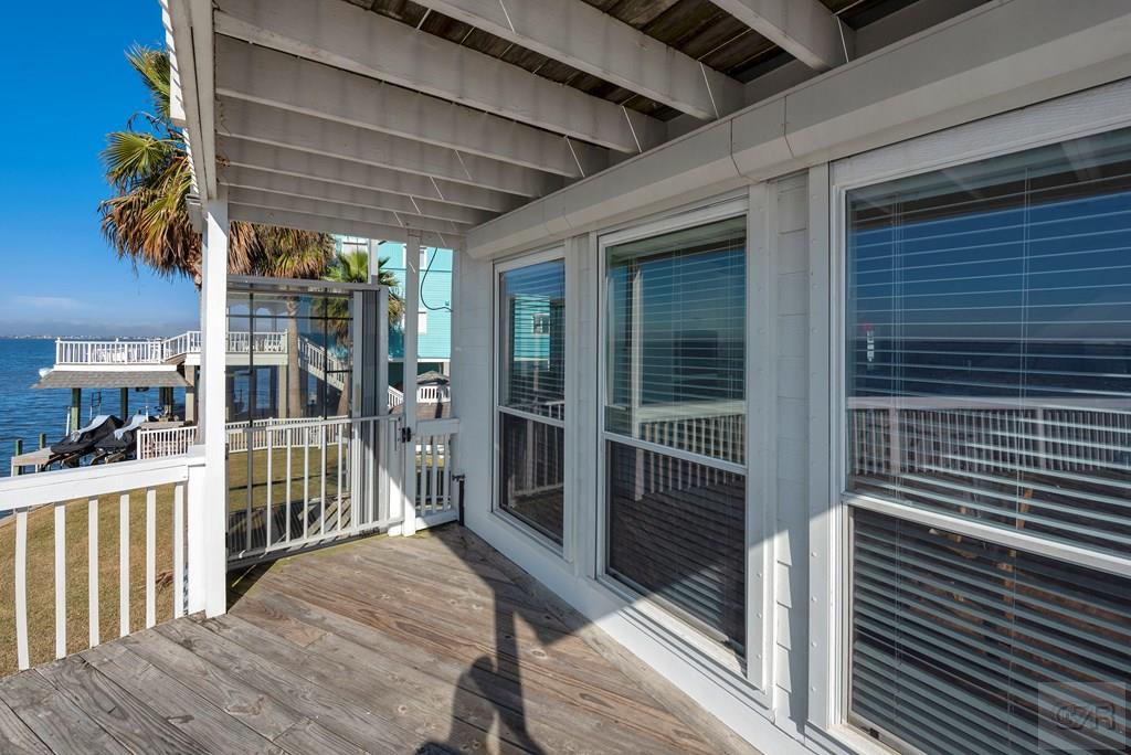 131 Isles End Road Tiki Island, TX 77554 - Photo 39 of 48 a porch with a table and chairs