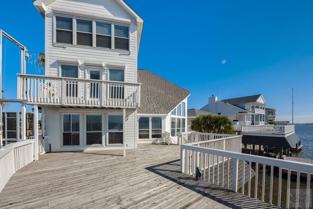 131 Isles End Road Tiki Island, TX 77554 - Photo 40 of 48 a view of a house with wooden deck