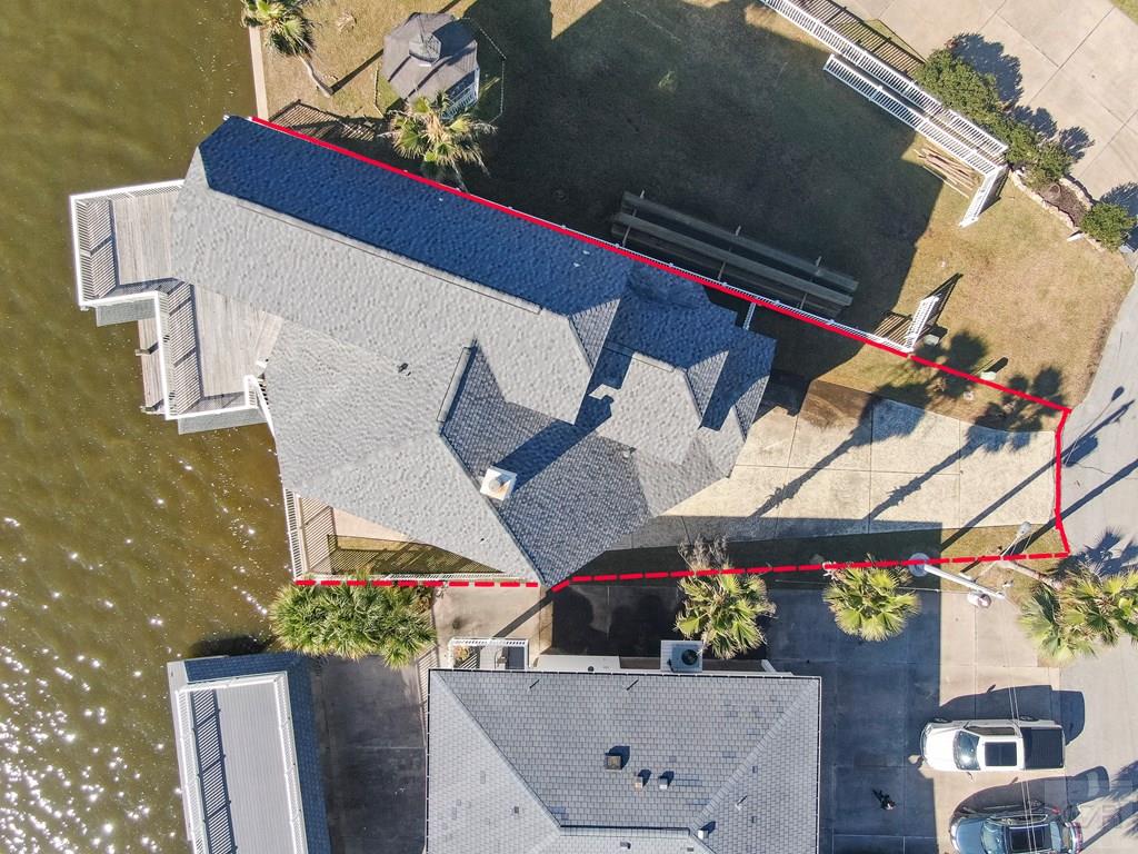 131 Isles End Road Tiki Island, TX 77554 - Photo 4 of 48 an aerial view of a house with a yard