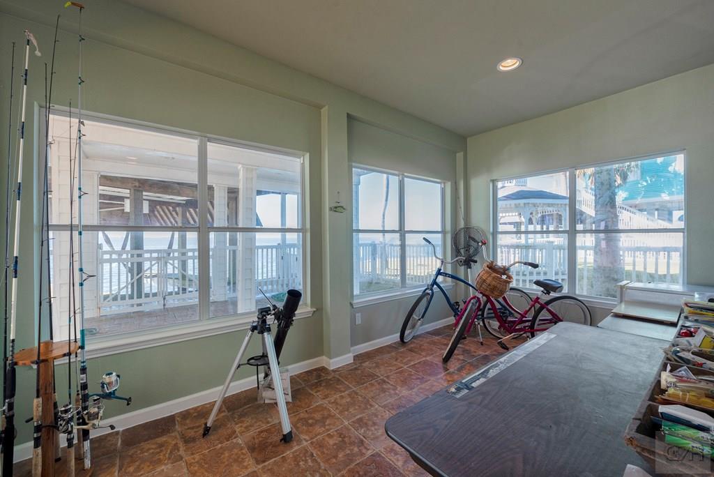 131 Isles End Road Tiki Island, TX 77554 - Photo 42 of 48 a living room with furniture a large window and gym equipment