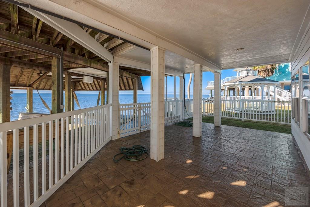 131 Isles End Road Tiki Island, TX 77554 - Photo 45 of 48 a view of a porch with wooden floor and fence