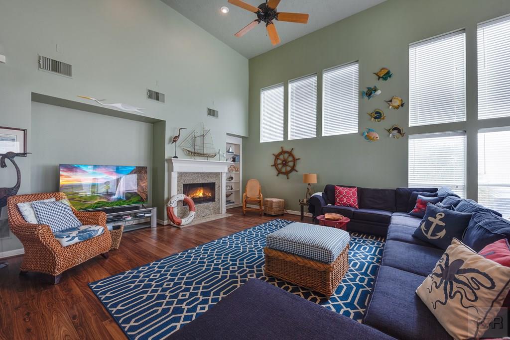 131 Isles End Road Tiki Island, TX 77554 - Photo 9 of 48 a living room with furniture a fireplace and a flat screen tv