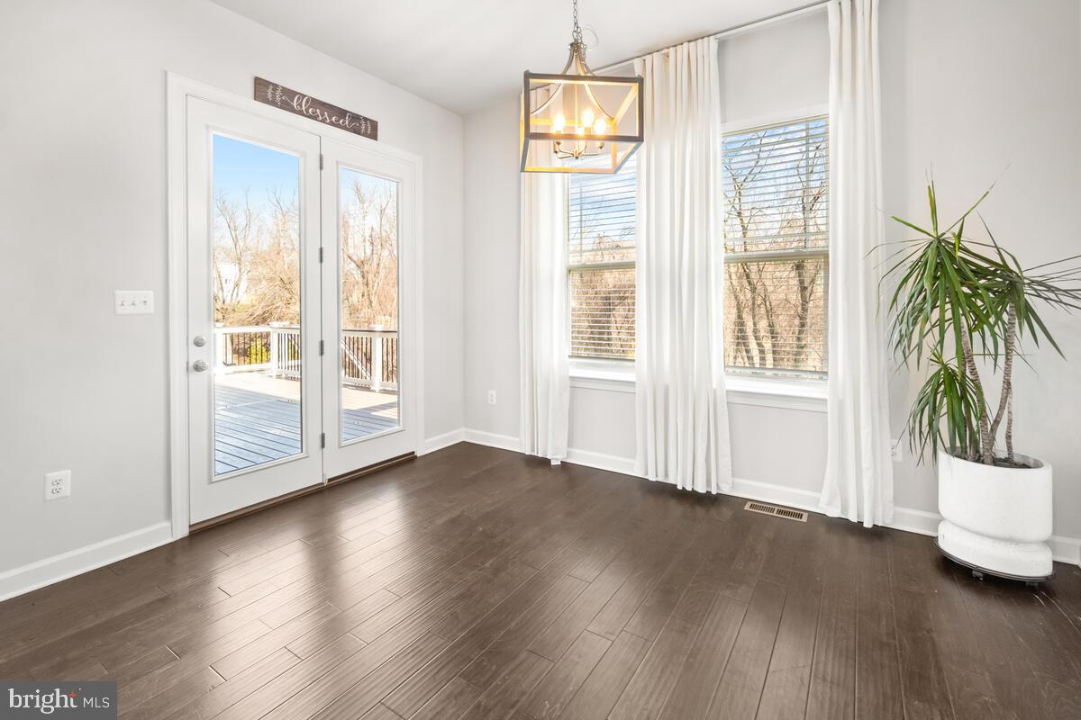 5521 Hawk Ridge Road Frederick, MD 21704 - Photo 17 of 66 an empty room with wooden floor and windows