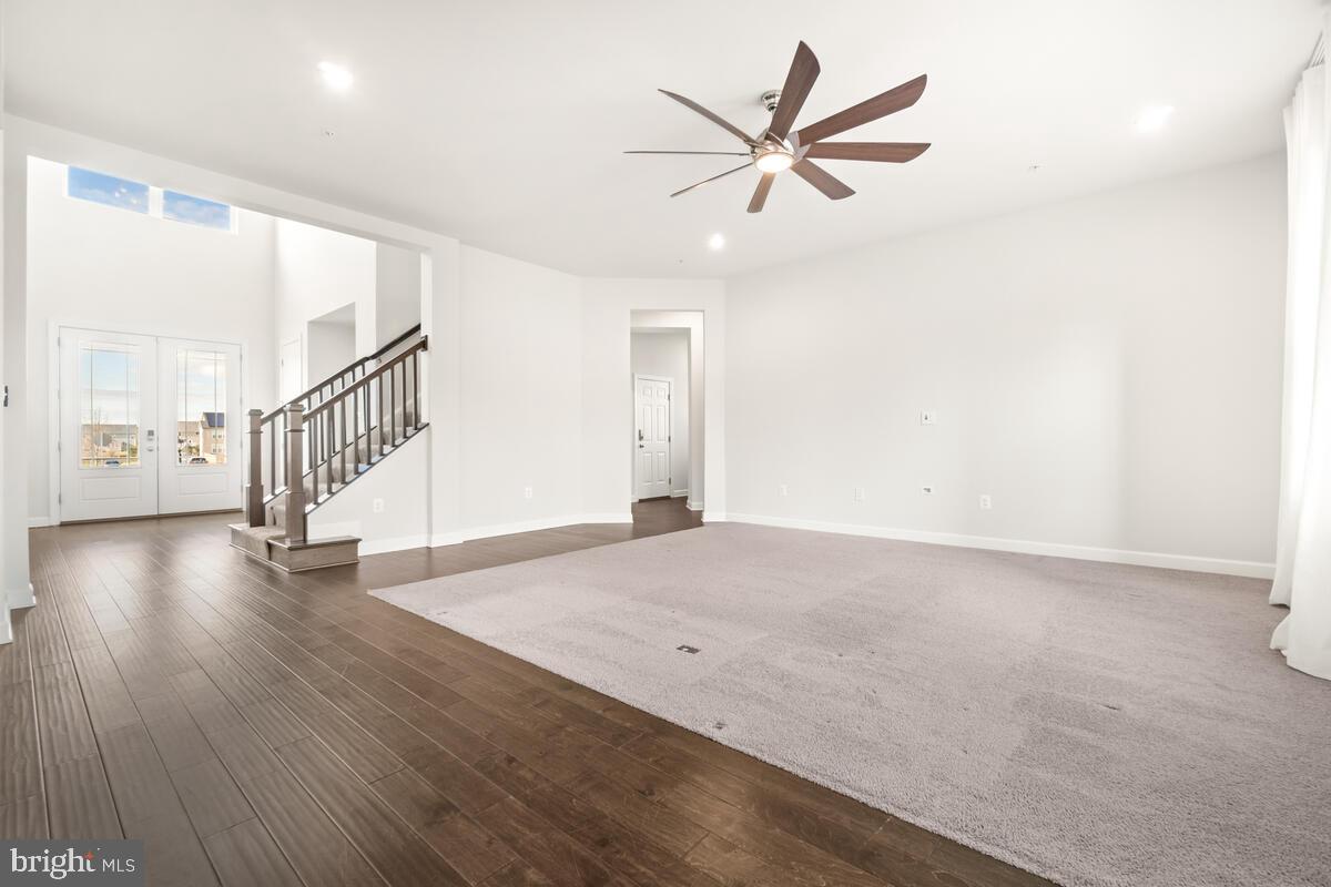 5521 Hawk Ridge Road Frederick, MD 21704 - Photo 18 of 66 a view of a livingroom with wooden floor and a ceiling fan