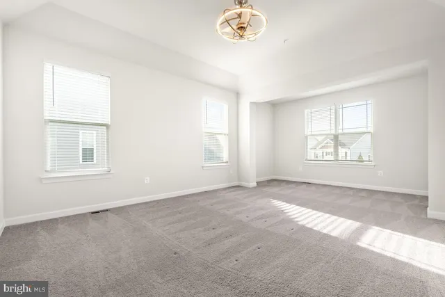 a spacious bathroom with a bathtub a large window and a sink