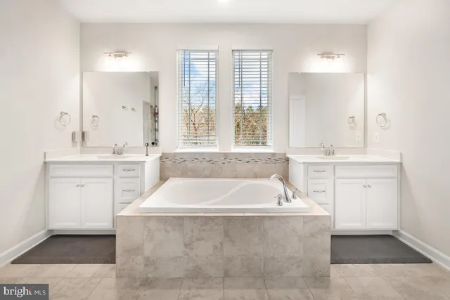 a bathroom with a double vanity sink and mirror