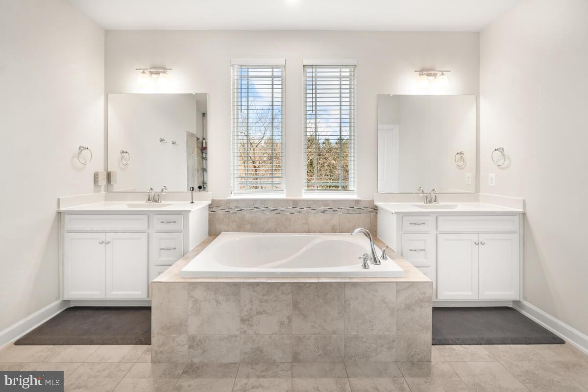 5521 Hawk Ridge Road Frederick, MD 21704 - Photo 29 of 66 a spacious bathroom with a bathtub a large window and a sink