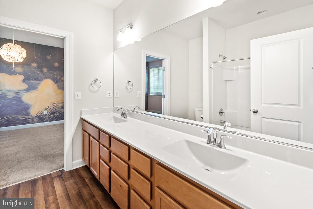 5521 Hawk Ridge Road Frederick, MD 21704 - Photo 33 of 66 a bathroom with a double vanity sink and mirror