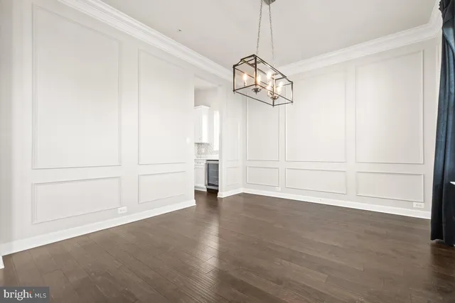 a view of kitchen with wooden floor and electronic appliances