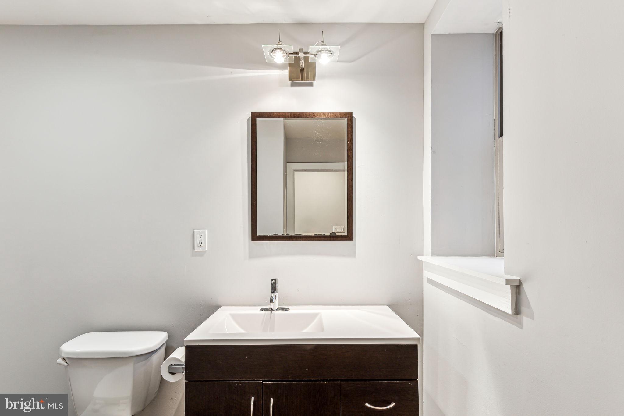 1418 Christian Street, Unit 1 Philadelphia, PA 19146 - Photo 11 of 28 a bathroom with a sink and a toilet