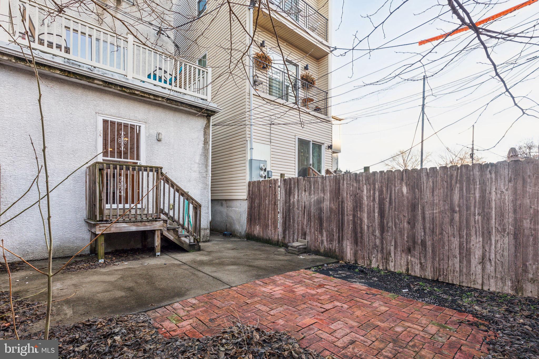 1418 Christian Street, Unit 1 Philadelphia, PA 19146 - Photo 17 of 28 a view of a house with a wooden deck